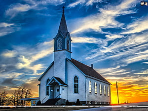 White wooden church with steeple against dramatic sunset sky HD wallpaper