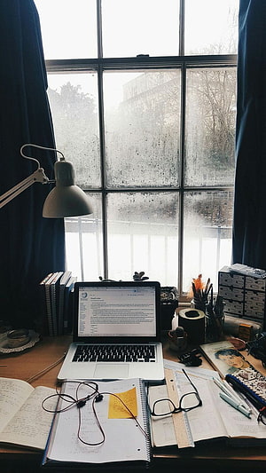 Cozy Study Desk Setup with Laptop, Notebooks, and Desk Lamp by a Foggy Window HD phone wallpaper