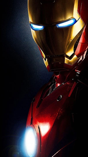 Iron Man Close-Up Portrait with Glowing Blue Eyes and Arc Reactor on Dark Background HD phone wallpaper
