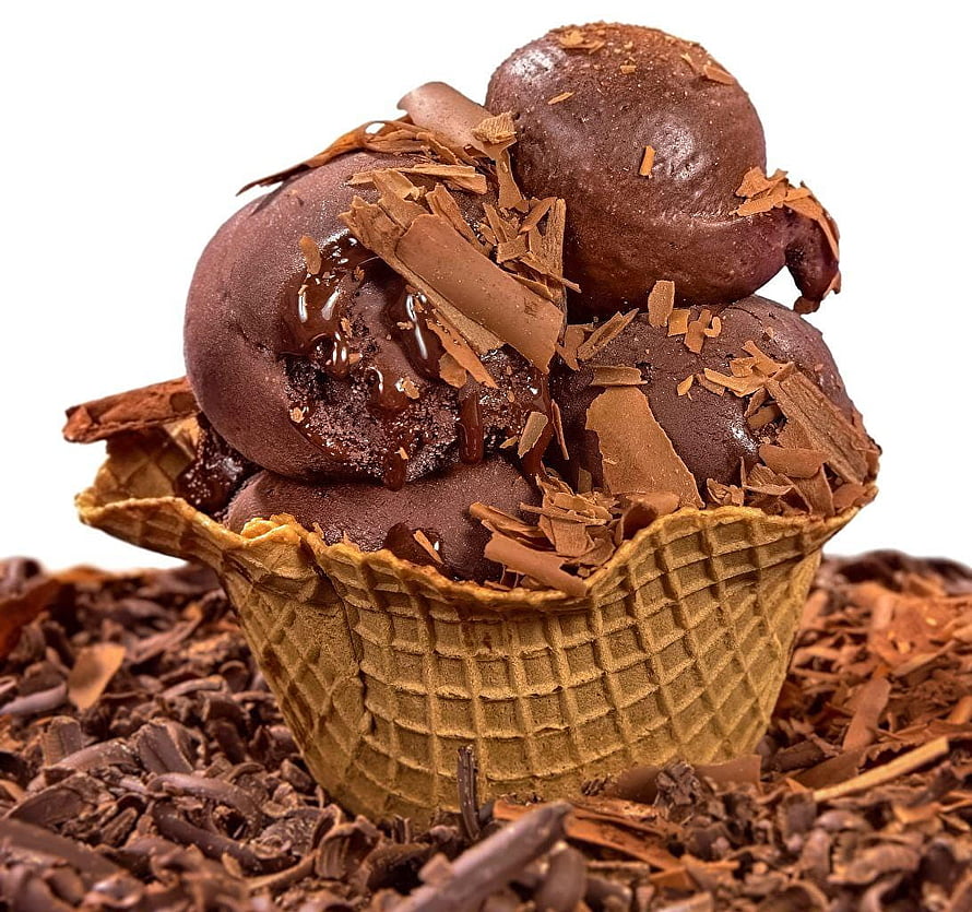 Rich chocolate ice cream scoops in a waffle cone topped with chocolate shavings and syrup HD wallpaper