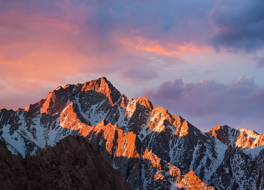 Alpine Mountain Peaks Bathed in Golden Sunset Light with Snowy Ridges HD wallpaper