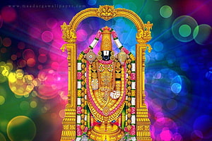 Lord Venkateswara adorned in gold ornaments and floral garlands within a golden archway HD wallpaper