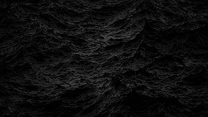 Dark Textured Black Surface with Organic Ripples and Deep Shadows HD wallpaper