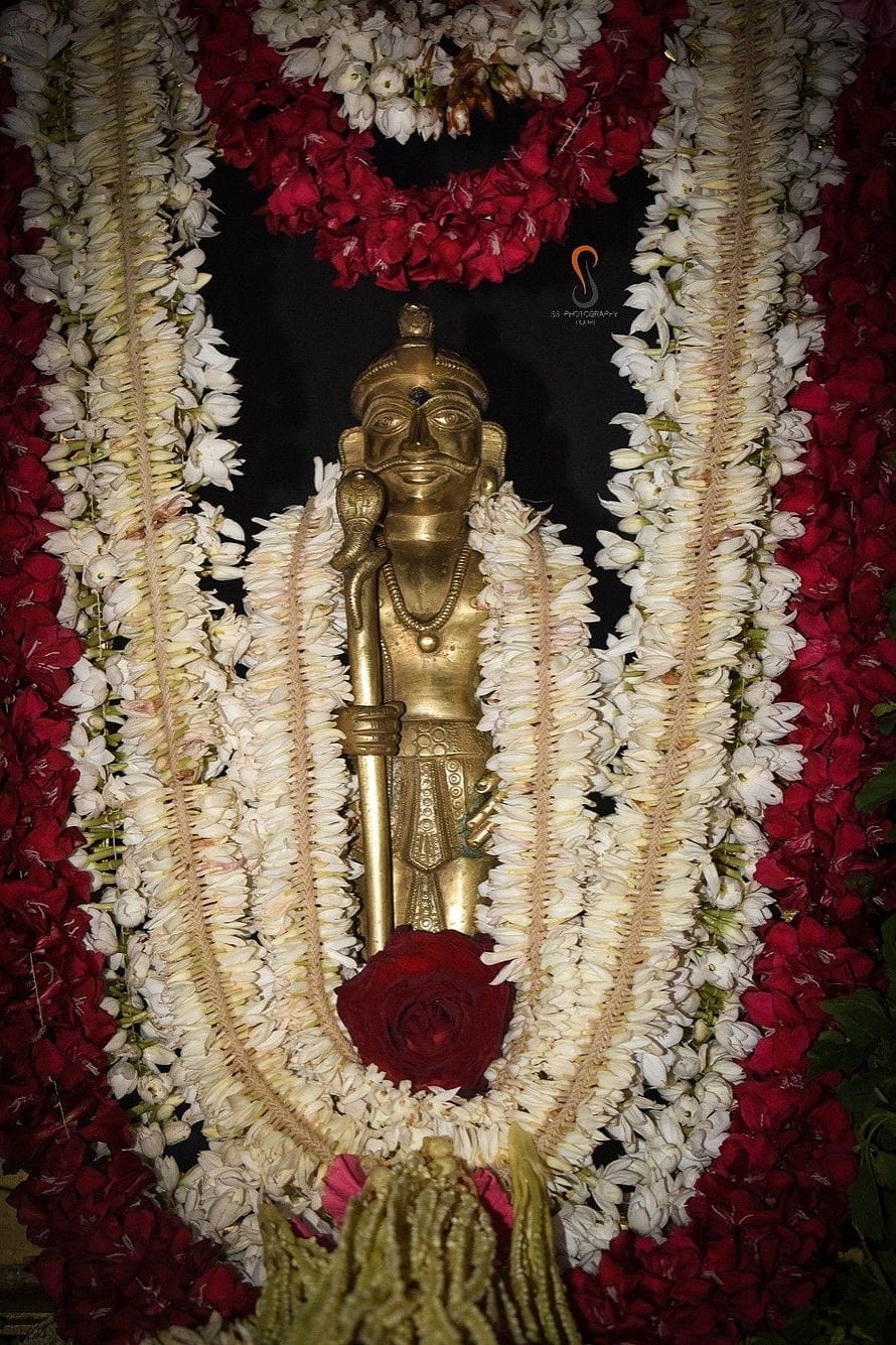 Koragajja Deity Adorned With Jasmine and Rose Flower Garlands in Temple Setting HD phone wallpaper