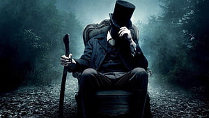 Victorian Gentleman in Top Hat Seated in Misty Forest HD wallpaper