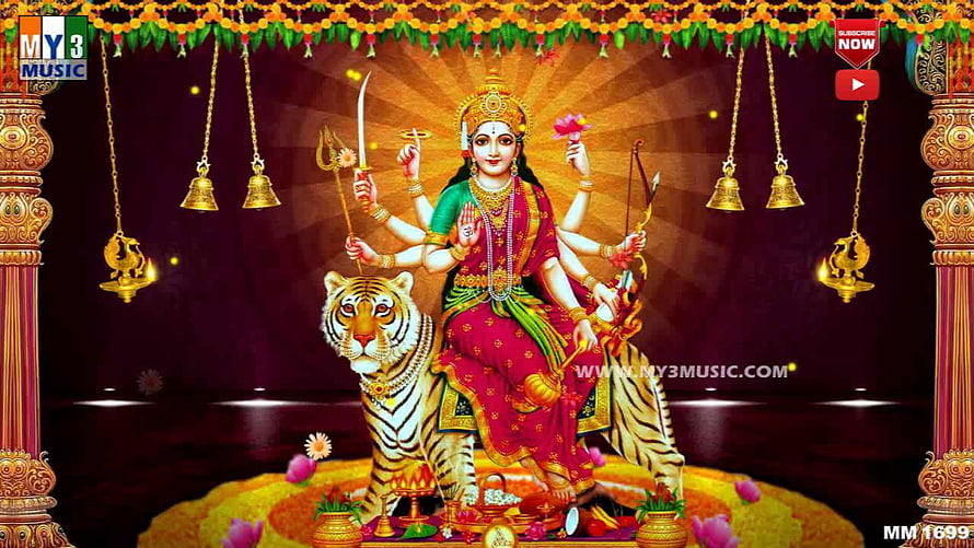 Kanaka Durga riding a tiger with multiple arms holding sacred weapons and a lotus flower HD wallpaper