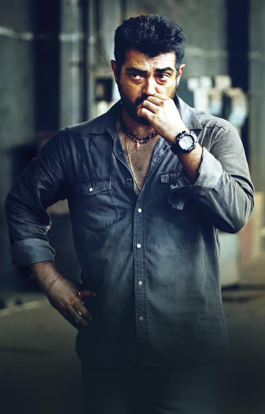 Ajith Kumar in a moody portrait wearing a dark button-up shirt with a serious expression HD phone wallpaper