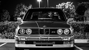 Front View of a Classic BMW M3 E30 in Black and White Night Photography HD wallpaper