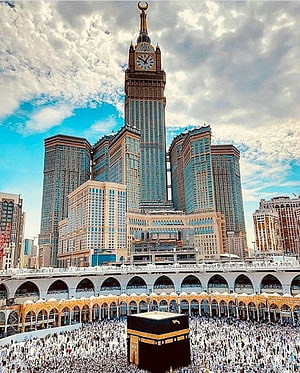 The Grand Makkah Clock Tower and Kaaba with Pilgrims in Mecca HD phone wallpaper