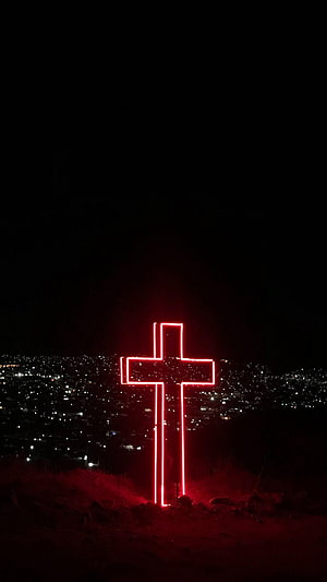 Illuminated Red Christian Cross Overlooking a City at Night HD phone wallpaper