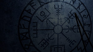 Ancient Norse Rune Circle Carved in Dark Stone with Shadowy Atmosphere HD wallpaper