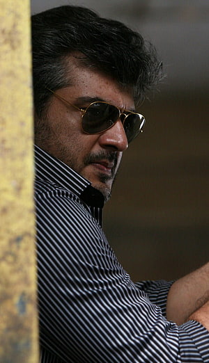 Ajith Kumar in Mankatha wearing aviator sunglasses and striped shirt HD phone wallpaper