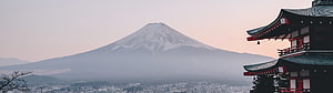 Mount Fuji Rising Above Misty Cityscape with Traditional Japanese Pagoda HD wallpaper