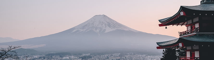 Mount Fuji Rising Above Misty Cityscape with Traditional Japanese Pagoda HD wallpaper
