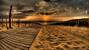 Dramatic Golden Hour Beach Sunset with Wooden Boardwalk and Sand Dunes HD wallpaper