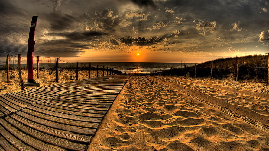 Dramatic Golden Hour Beach Sunset with Wooden Boardwalk and Sand Dunes HD wallpaper