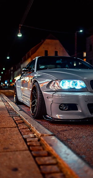 Silver BMW E46 M3 with LED Headlights Parked on Cobblestone Street at Night HD phone wallpaper
