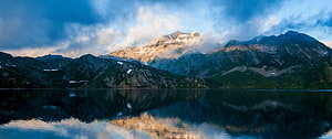 Majestic Mountain Lake Reflection at Golden Hour with Dramatic Clouds HD wallpaper