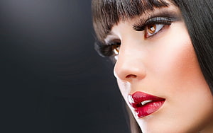 Close-up beauty portrait of a woman with bold red lips and dramatic eye makeup HD wallpaper