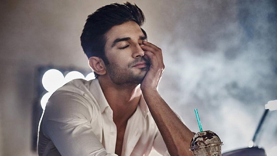 Sushant Singh Rajput in a contemplative pose with a white shirt and iced coffee HD wallpaper