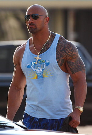 Dwayne Johnson in a light blue tank top with sunglasses and a gold cross necklace HD phone wallpaper