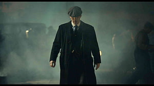 Peaky Blinders Tommy Shelby Walking Through Smoky Industrial Night Scene HD wallpaper