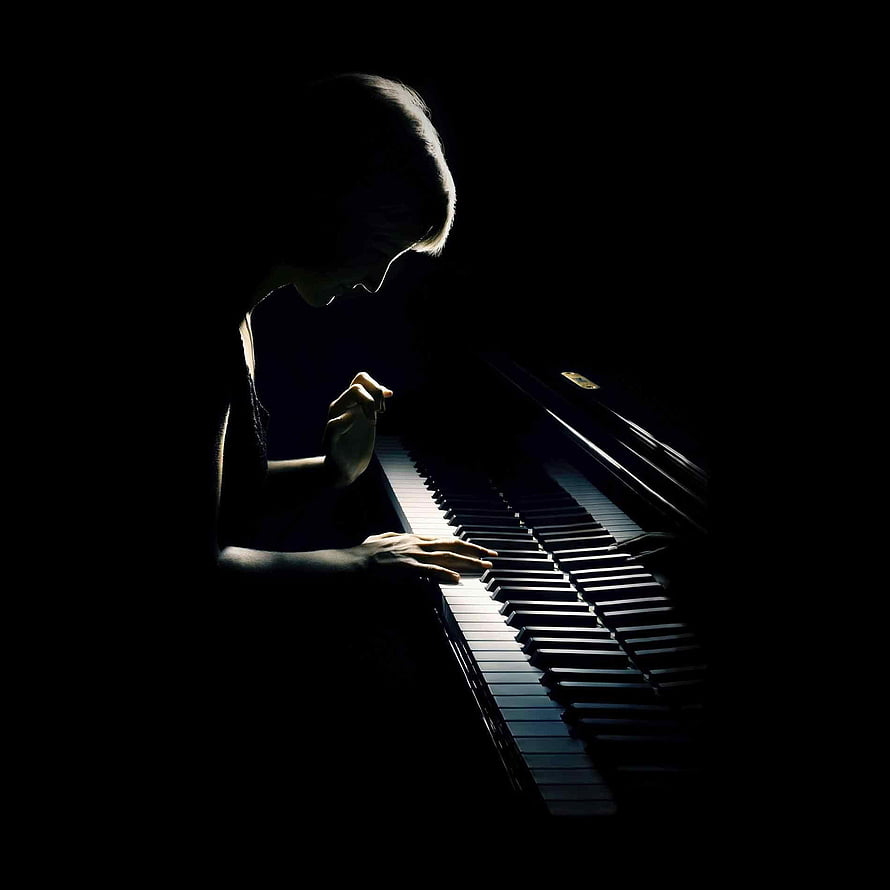 Woman Playing Grand Piano in Dramatic Low-Key Lighting HD phone wallpaper