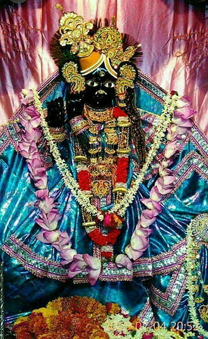 Ornate Radha Krishna Murti Adorned in Traditional Jewelry and Floral Garlands HD phone wallpaper