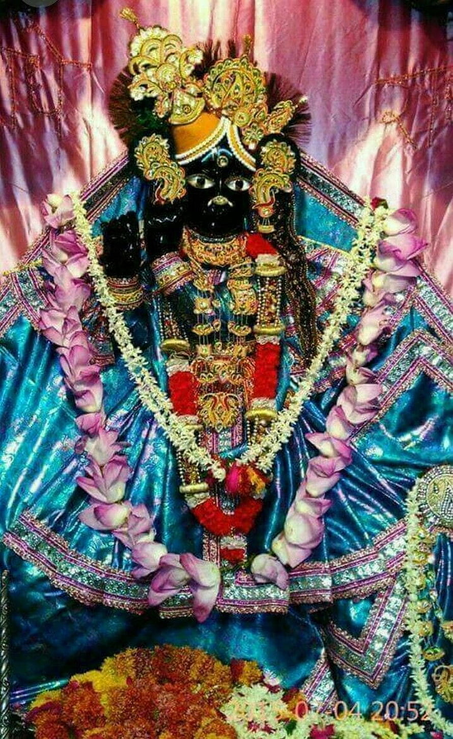 Ornate Radha Krishna Murti Adorned in Traditional Jewelry and Floral Garlands HD phone wallpaper