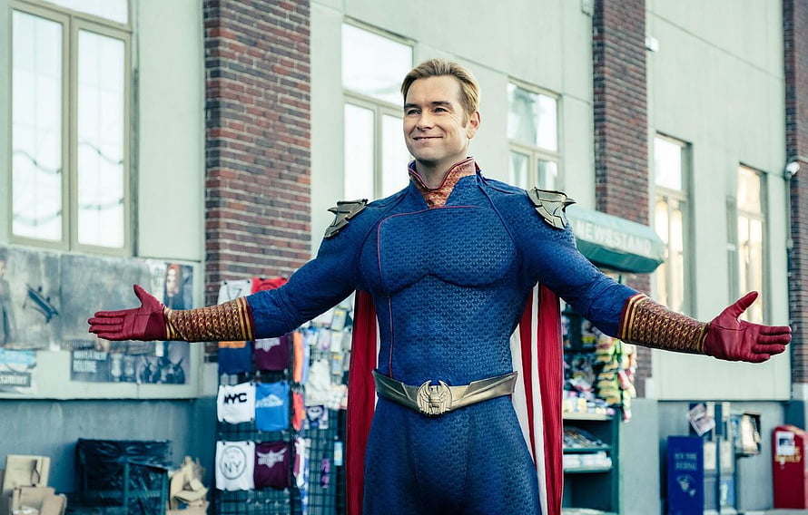 Homelander from The Boys in blue superhero costume with arms spread wide in front of a newsstand HD wallpaper