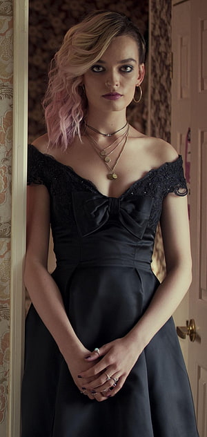Emma Mackey in a black lace off-shoulder gown with a large satin bow and layered gold necklaces HD phone wallpaper
