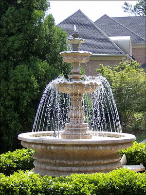 Ornate Three-Tier Garden Water Fountain with Flowing Water Jets in a Lush Green Landscape HD phone wallpaper