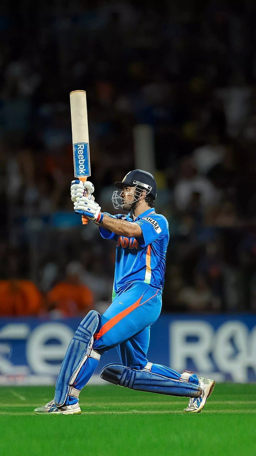 MS Dhoni in Indian cricket kit executing a powerful batting stroke on the field HD phone wallpaper