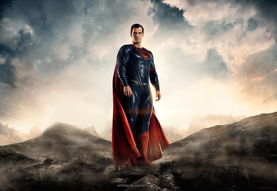Superman Standing on Rocky Terrain in Dramatic Cinematic Light HD wallpaper
