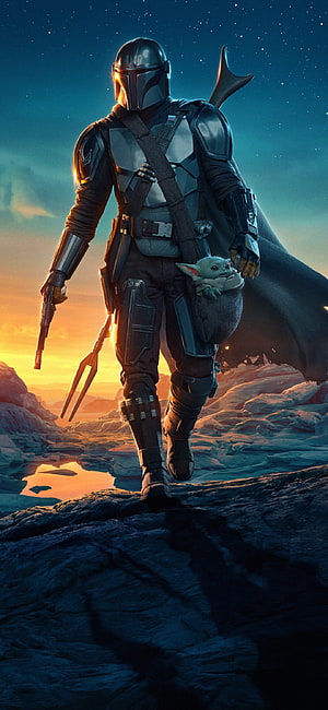 The Mandalorian and Grogu Walking Through a Rocky Desert at Sunset HD phone wallpaper
