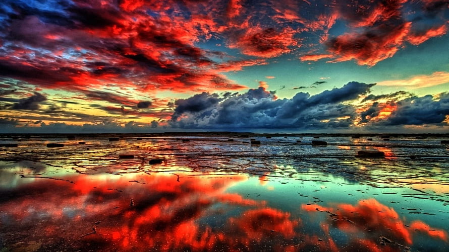 Vivid Red Clouds Reflected in Shallow Water at Sunset HD wallpaper
