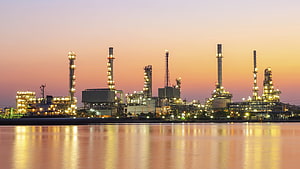 Illuminated Oil Refinery Complex at Dusk with Water Reflections HD wallpaper