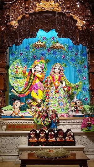 Iskcon Krishna and Radha Temple Deity with Ornate Carved Woodwork and Floral Garlands HD phone wallpaper
