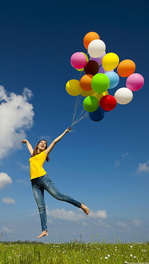 Joyful Woman Jumping With Colorful Balloons In A Sunny Meadow HD phone wallpaper