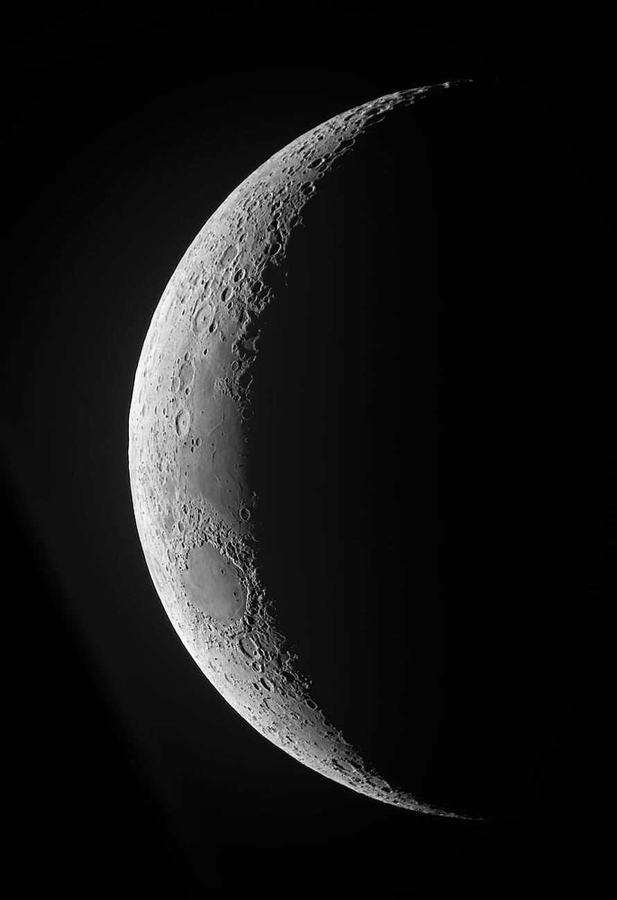 Waxing Crescent Moon with Cratered Surface Against Deep Black Sky HD phone wallpaper