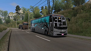 Grey Touring Bus with Cyan Tree Decal Driving on Mountain Road HD wallpaper