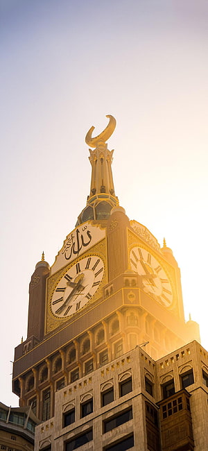 Makkah Royal Clock Tower with Golden Crescent and Arabic Calligraphy at Golden Hour HD phone wallpaper
