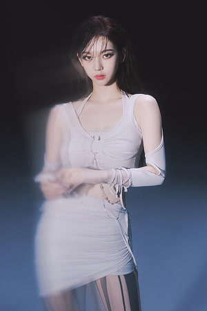 Karina from aespa in a white halter top and ruched skirt with dramatic studio lighting HD phone wallpaper