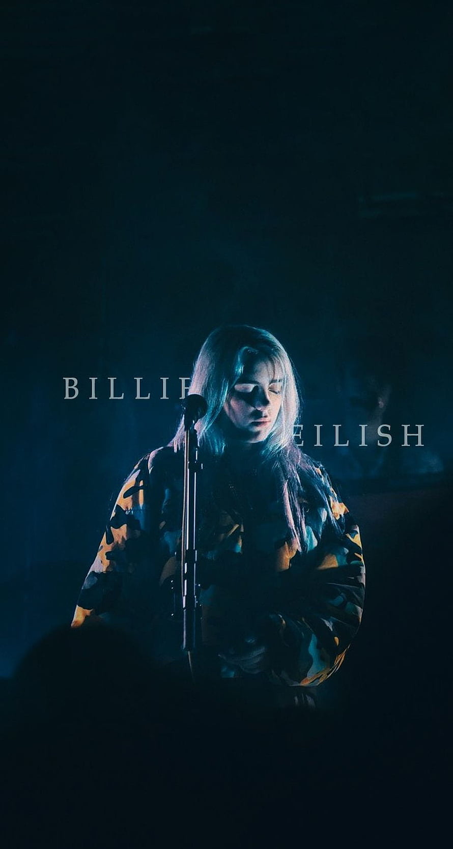 Billie Eilish performing on stage in moody blue lighting with microphone HD phone wallpaper