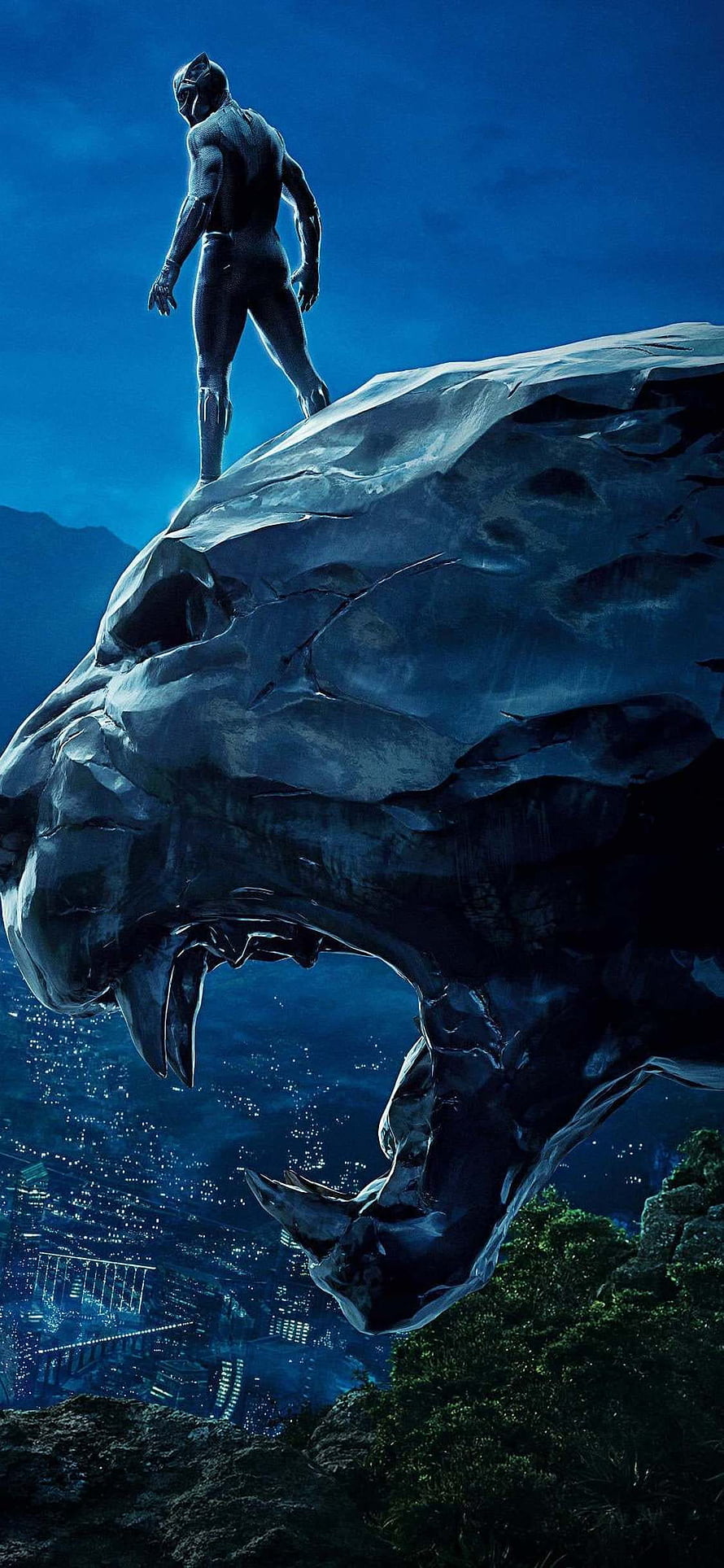 Black Panther standing atop a massive stone panther head overlooking a city at night HD phone wallpaper