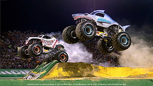Monster Jam Trucks Megalodon and Grave Digger Launching Over Dirt Ramp at Night HD wallpaper