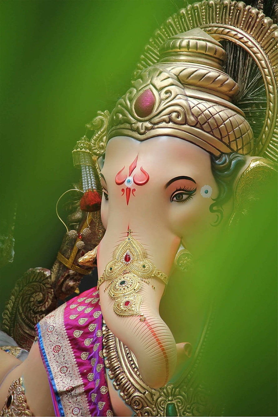 Chintamani Ganpati Murti with Ornate Gold Crown and Traditional Indian Attire HD phone wallpaper