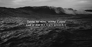 Moody Black and White Ocean Wave with Emotional Lyrics Overlay HD wallpaper