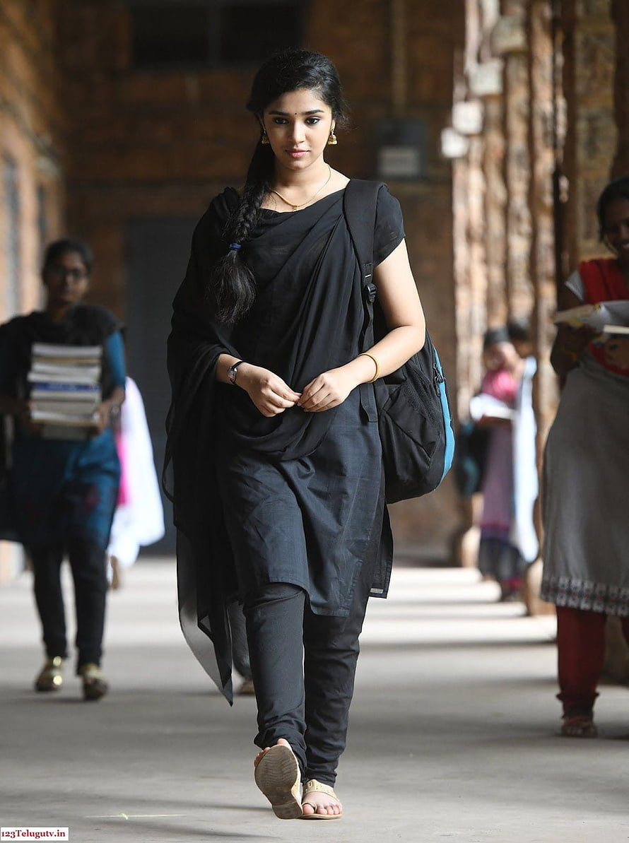 Krithi Shetty in Black Ethnic Wear Walking Through a Historic Corridor HD phone wallpaper
