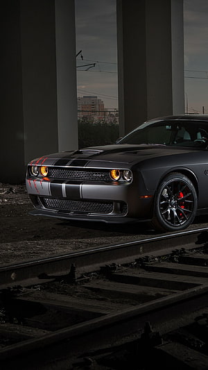 2019 Dodge Challenger SRT Hellcat with red accents parked on railway tracks under an overpass HD phone wallpaper